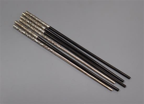 Six assorted Chinese white metal mounted chopsticks.